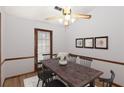 Dining room showcasing a wooden table set for six, hardwood floors, and natural light at 4223 Mountain Glen Trce, Snellville, GA 30039