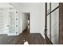 Bright entryway with hardwood floors, crisp white walls, and unique architectural details at 262 Green Hill Ne Rd, Sandy Springs, GA 30342