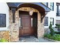 Grand entrance featuring a stone facade, a covered porch, and an elegant solid wood front door at 1352 Middlesex Ne Ave, Atlanta, GA 30306