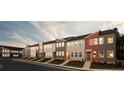 Striking row of new townhouses featuring multi-tone exteriors and professional landscaping at 1592 Driggs Nw Dr # 165, Atlanta, GA 30318