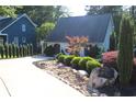 Charming home with well-manicured landscaping, rock accents, and a long driveway at 4040 Merritt Dr, Cumming, GA 30041