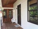 Inviting front porch features a wooden bench, coat hooks, and a welcome mat at 4040 Merritt Dr, Cumming, GA 30041