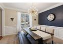 Stylish dining room with decorative lighting, wainscoting, and blue accent wall at 1283 Hada Ct, Lawrenceville, GA 30043