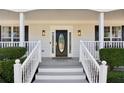 Elegant front door with decorative glass, flanked by sidelights, and white railing at 1283 Hada Ct, Lawrenceville, GA 30043