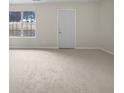 Spacious living room featuring a bright sunny day through the window and neutral colored walls at 3153 Kingswood Gln, Decatur, GA 30034