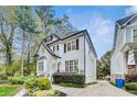 Charming two-story home with manicured landscaping and a stone driveway, under a bright blue sky at 3580 S Sherwood Se Rd, Smyrna, GA 30082