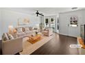 Bright living room with neutral colors, large windows, and stylish furnishings, virtually staged at 11403 S Grove Dr, Hampton, GA 30228