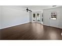 A well-lit living room featuring beautiful hardwood floors, and large windows at 11403 S Grove Dr, Hampton, GA 30228