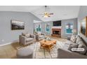 Cozy staged living room featuring a brick fireplace, neutral decor, and lots of natural light at 1681 Graystone Dr, Hampton, GA 30228