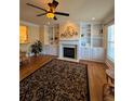 Bright living room with fireplace, built-in shelving, and view of the backyard at 2371 Bellefonte Ave # 61, Lawrenceville, GA 30043