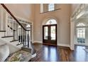 Grand foyer with soaring ceilings, hardwood floors, elegant staircase and large front entrance at 4634 Meadow Bluff Ln, Suwanee, GA 30024