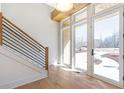 Bright foyer featuring hardwood floors, modern railing staircase, and natural light from the front door at 165 Cedarwood Ln, Roswell, GA 30075