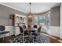Elegant dining room with gray walls, a wood table set, and a bright bay window at 2447 Tift Nw Ct, Kennesaw, GA 30152