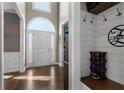 Inviting foyer with an arched doorway, hardwood floors, and a convenient shoe storage area at 2447 Tift Nw Ct, Kennesaw, GA 30152