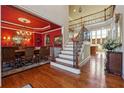 Elegant foyer showcasing hardwood floors, a staircase with iron railings, and a view into the dining room at 2916 Kings Walk Ave, Marietta, GA 30062
