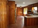 Spacious kitchen and dining area with wood paneling and an island at 2374 Woodcastle Se Ln, Atlanta, GA 30316