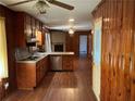 Open kitchen with wood cabinets, stainless steel dishwasher, and wood paneling at 2374 Woodcastle Se Ln, Atlanta, GA 30316