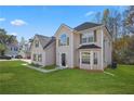 Beautiful two-story home featuring manicured lawn, dark roof, and green shutters at 3649 Salem Glen Rd, Lithonia, GA 30038