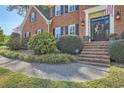 Charming brick home entrance featuring a decorated front door, brick steps, and mature landscaping at 4742 Balmoral Ne Way, Marietta, GA 30068