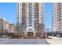 Exterior shot of high-rise condominiums featuring a roundabout at 799 Hammond Dr # 219, Atlanta, GA 30328