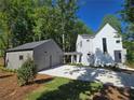 This modern home has a two-car garage and a connecting breezeway, adding convenience and curb appeal at 145 Cedarwood Ln, Roswell, GA 30075