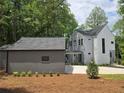 View of a modern home's exterior with a detached garage and covered walkway at 145 Cedarwood Ln, Roswell, GA 30075