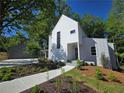 Charming two-story home with a concrete walkway leading to the front door and well-manicured landscaping at 145 Cedarwood Ln, Roswell, GA 30075