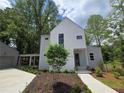 Charming two-story home with modern architecture and landscaped front yard at 145 Cedarwood Ln, Roswell, GA 30075