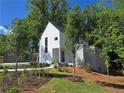 Inviting home with a modern design, complemented by a well-maintained lawn and mature trees at 145 Cedarwood Ln, Roswell, GA 30075