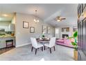 Open-concept living space featuring an adjacent kitchen, fireplace, and dining area at 2139 Hickory Se Bnd # E, Conyers, GA 30013