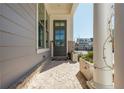 Welcoming front porch with decorative columns, a stylish front door, and beautiful landscaping, enhancing curb appeal at 906 Bingham St, Woodstock, GA 30188