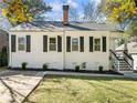 Lovely white brick house with black shutters, green lawn, and inviting front entrance at 1764 Springview Nw Rd, Atlanta, GA 30314