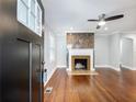 Bright living room features hardwood floors, fireplace, and modern ceiling fan at 1764 Springview Nw Rd, Atlanta, GA 30314