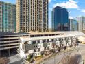 Aerial view of townhomes, parking deck and high-rise buildings in a vibrant cityscape at 223 16Th Nw St # 2, Atlanta, GA 30363