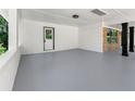 Spacious carport with painted brick walls, modern lighting, and access to the front door at 2682 Miriam Ln, Decatur, GA 30032
