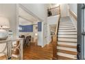 Bright and airy foyer with hardwood floors, staircase, and an open view to the dining room at 2871 Parkridge Ne Dr, Brookhaven, GA 30319