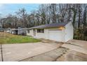 This home includes an attached garage and a long driveway at 1492 Cobb Branch Dr, Decatur, GA 30032