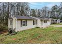 View of the side of the house with an attached garage and small yard at 1492 Cobb Branch Dr, Decatur, GA 30032