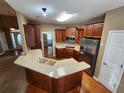 Open concept kitchen with stainless steel appliances, a breakfast bar, and ample storage at 959 Gettysburg Way, Locust Grove, GA 30248