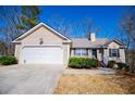 Attractive one-story home with a well-manicured lawn and an attached two-car garage at 185 Whetstone Way, Villa Rica, GA 30180