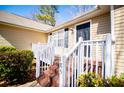 Inviting front porch with white railings and wood stairs leading to the front door at 185 Whetstone Way, Villa Rica, GA 30180