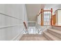 Traditional staircase with carpeted steps, a decorative railing, and white trim at 2790 Laurel Valley Trl, Buford, GA 30519