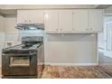 Kitchen showcasing laminate flooring, and black electric range at 1690 Carter Rd, Decatur, GA 30032