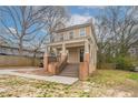 Inviting two-story home featuring a classic design and an open front porch at 3040 Washington Rd, Atlanta, GA 30344