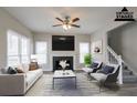 Bright living room with a fireplace, large windows, and stylish neutral decor at 3040 Washington Rd, Atlanta, GA 30344