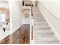 Inviting entryway with hardwood floors, staircase and decorative wainscoting at 6188 Riddle Ct, Douglasville, GA 30134