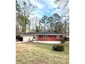 View of the home's exterior, featuring a combination of red brick and light-colored siding, complemented by a well-maintained lawn at 2182 Rosewood Rd, Decatur, GA 30032