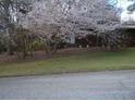 Charming home with flowering tree in front yard and a red door for added curb appeal at 3315 Canterbury Trl, Rex, GA 30273