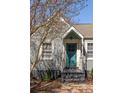 Close-up of charming home entrance featuring a quaint porch and a teal front door at 1046 Faith Se Ave, Atlanta, GA 30316