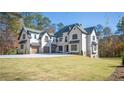 Spacious two-story home with an attached garage and expansive front yard at 10745 Shallowford Rd, Roswell, GA 30075